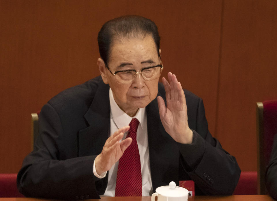 CORRECTS AGE TO 90, INSTEAD OF 91 - In this Oct. 24, 2017, photo, former Chinese Premier Li Peng, reach for his neck during the closing session of China's 19th Party Congress at the Great Hall of the People in Beijing, China. Li Peng, a former hard-line Chinese premier best known for announcing martial law during the 1989 Tiananmen Square pro-democracy protests, has died on Monday July 22, 2019 of unspecified illness. He was 90. (AP Photo/Ng Han Guan)