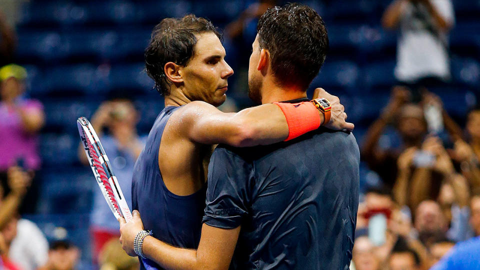 Rafael Nadal showed his class by jumping over the net to embrace Dominic Thiem. Pic: Getty