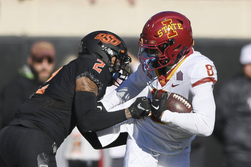 Oklahoma State cornerback Korie Black (2) attempts to knock the ball out of the hands of Iowa State wide receiver Xavier Hutchinson (8) during the first half of an NCAA college football game Saturday, Nov. 12, 2022, in Stillwater, Okla. (AP Photo/Brody Schmidt)