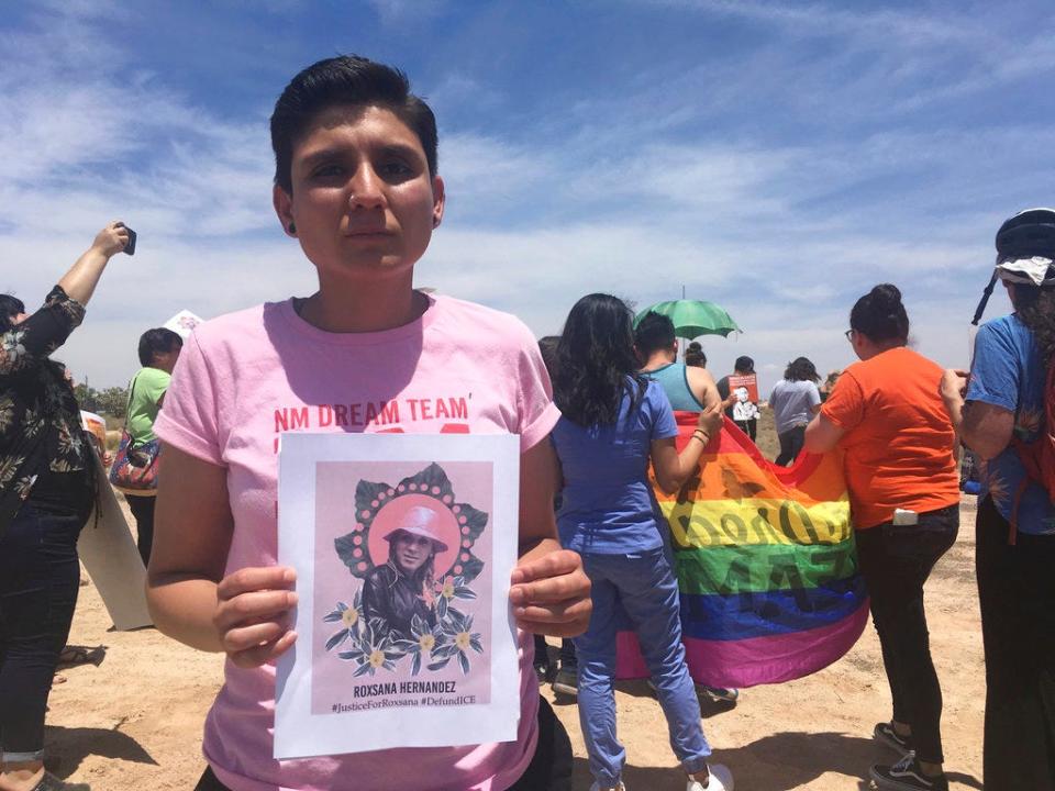 In this Wednesday, June 6, 2018 file photo, Gabriela Hernandez, executive director of the nonprofit New Mexico Dream Team, holds up an image in Albuquerque, New Mexico, of a Honduran transgender woman who died while in U.S. custody last month.