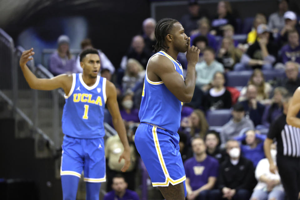 UCLA guard David Singleton reacts after sinking a three point shot with guard Abramo Canka during the first half of an NCAA college basketball game against Washington, Sunday, Jan. 1, 2023, in Seattle. (AP Photo/John Froschauer)