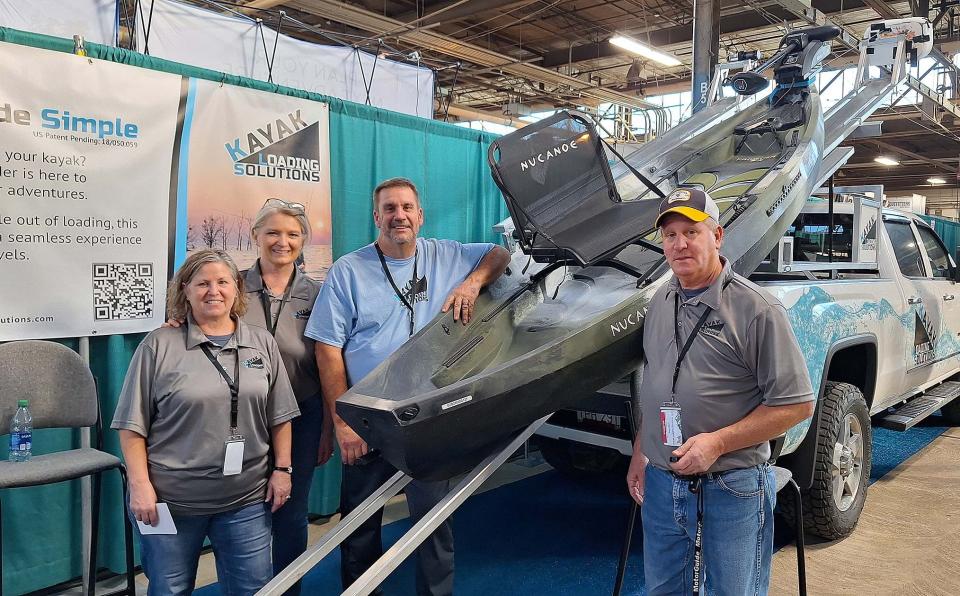 From left, Linda, Vicki, Jeff and Greg Wilson of Kayak Loading Solutions (KLS) demonstrate how easy it can be to load a kayak on a truck with their product.