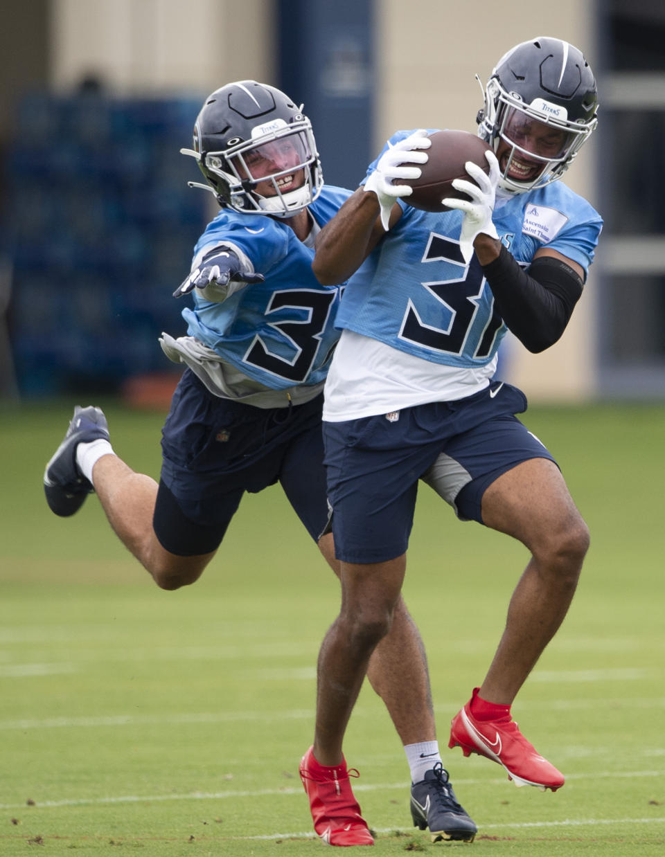 Tennessee Titans safety Kevin Byard (31) pulls in a pass against safety Amani Hooker, left, during an NFL football practice Thursday, June 10, 2021, in Nashville, Tenn. (George Walker IV/Pool Photo via AP)