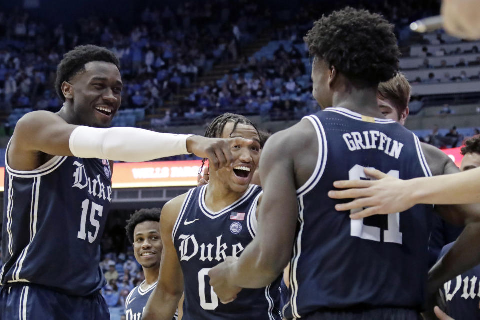 Duke center Mark Williams (15) and forward Wendell Moore Jr. (0) congratule forward A.J. Griffin (21) as he comes out of the game late in the second half of an NCAA college basketball game, Saturday, Feb. 5, 2022, in Chapel Hill, N.C. Griffin was Duke's leading scorer. (AP Photo/Chris Seward)