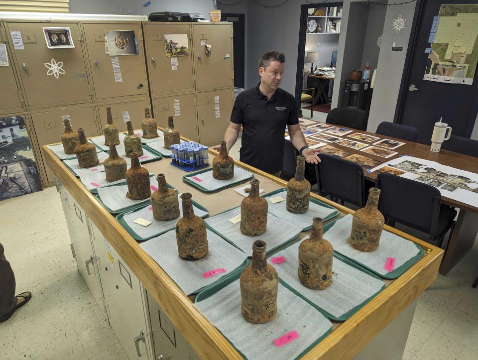 Archeologist Jason Boroughs discusses artifacts found underneath George Washington's residence in Mount Vernon, Va., Monday June 17, 2024. Earlier this year, a few dozen 18thcentury glass bottles containing fruit were unearthed in the mansion cellar of the America's first president. (AP Photo/Nathan Ellgren)