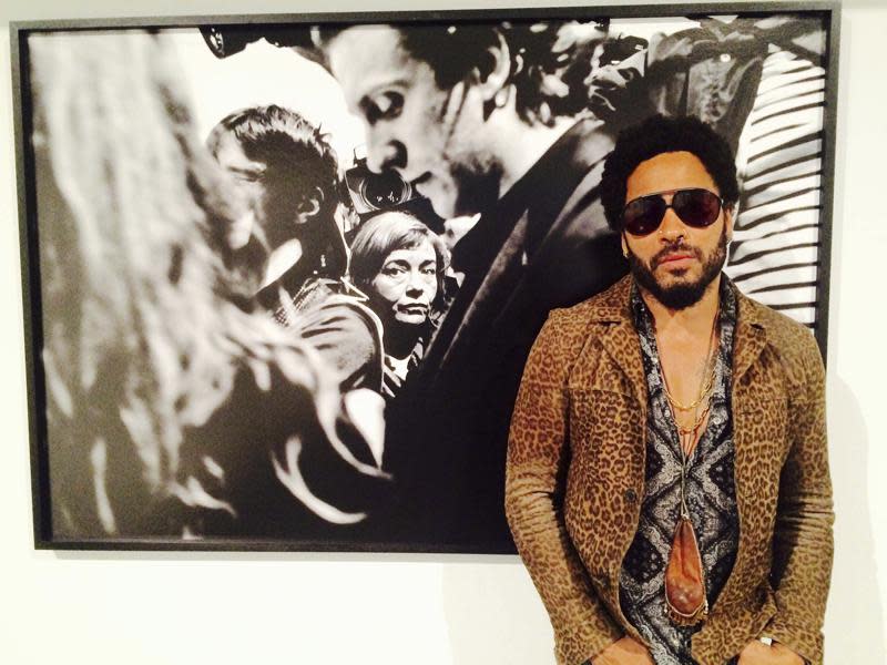 FILE – In this image taken from video, Musician Lenny Kravitz stands in front of one of his photos from his exhibit “Flash”, which is running in conjunction with Art Basel in Miami Beach, Wednesday, Dec. 2, 2015. Kravitz gave a private performance, Friday, Dec. 3, 2021, for a star-studded crowd that included Leonardo DiCaprio and local Latin boy band CNCO during Miami’s Art week. (AP Photo/Joshua Replogle, File)