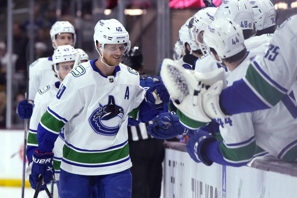 Vancouver Canucks center Elias Pettersson (40) is congratulated for his goal against the Arizona Coyotes during the first period during an NHL hockey game Thursday, April 13, 2023, in Tempe, Ariz. (AP Photo/Rick Scuteri)