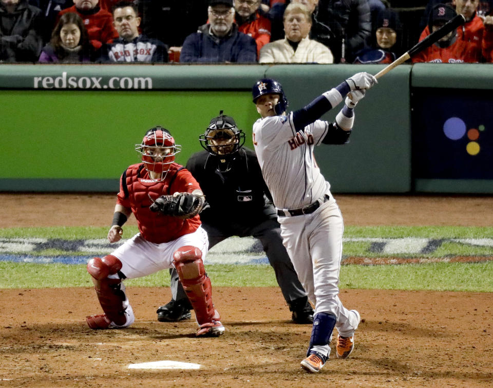 Houston Astros' Yuli Gurriel watches his three-run home run against the Boston Red Sox during the ninth inning in Game 1 of a baseball American League Championship Series on Saturday, Oct. 13, 2018, in Boston. (AP Photo/Elise Amendola)