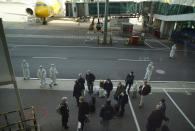 Members of the WHO team gather after arriving at the airport in Wuhan in central China's Hubei province on Thursday, Jan. 14, 2021. A global team of researchers arrived Thursday in the Chinese city where the coronavirus pandemic was first detected to conduct a politically sensitive investigation into its origins amid uncertainty about whether Beijing might try to prevent embarrassing discoveries. (AP Photo/Ng Han Guan)