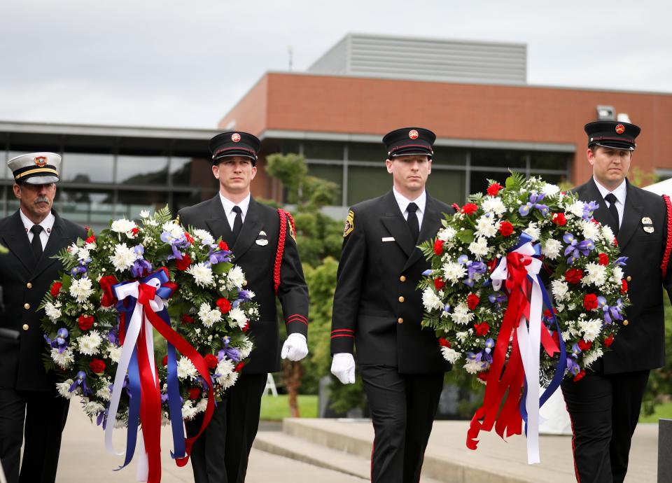 Wreaths are carried to the memorial to honor fallen Oregon firefighters during the Fallen Firefighters Memorial Ceremony on Thursday, June 9, 2022 in Salem, Ore.