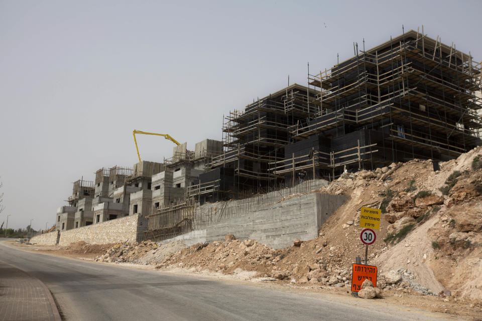 This photo taken Monday, March 3, 2014 shows a construction site in the Jewish settlement of Eli. Ahmed Awais has been desperate to get out of his parents' cramped home where he, his wife and three pre-school children share one room, sleeping on mattresses on the floor at night. (AP Photo/Sebastian Scheiner)