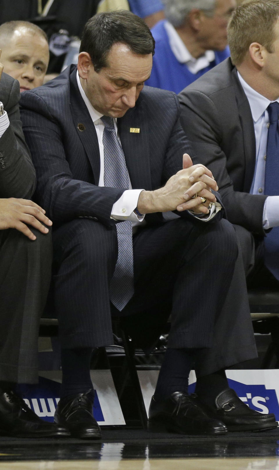 In this photo taken Wednesday, March 5, 2014, Duke head coach Mike Krzyzewski bows his head as he sits on the bench during the second half of an NCAA college basketball game against Wake Forest in Winston-Salem, N.C. Coach Krzyzewski is out of the hospital after feeling light-headed after a loss at Wake Forest. The school said in a statement Thursday, March 6, that Krzyzewski was taken to Duke University Hospital in Durham for a precautionary examination after the 82-72 loss in Winston-Salem.(AP Photo/Chuck Burton)