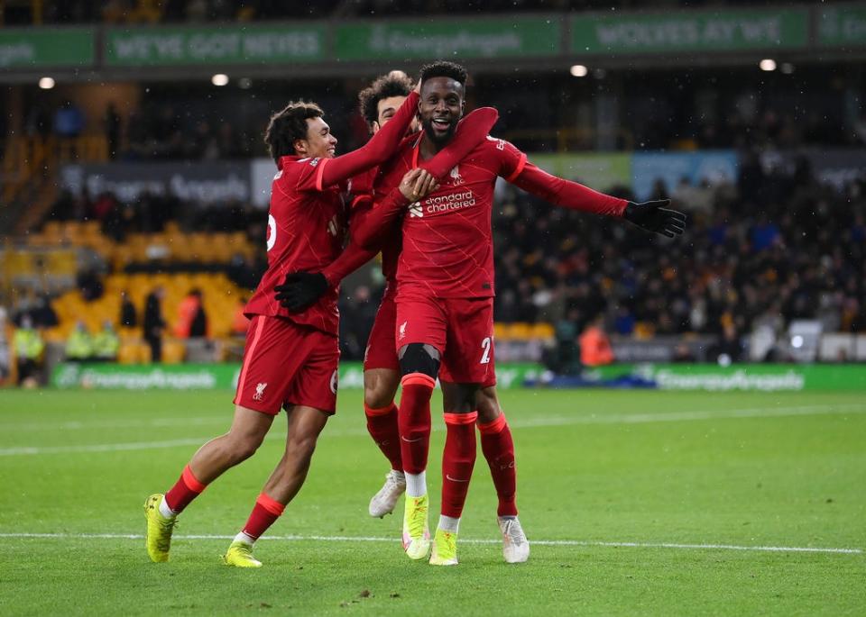 Divock Origi of Liverpool celebrates with Trent Alexander-Arnold and Mohamed Salah after scoring at Molineux (Getty)