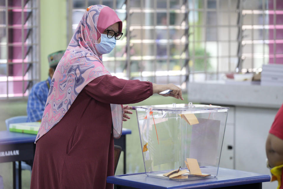 A voter cast her ballot for the state elections at a polling station in Selayang, outskirt of Kuala Lumpur, Malaysia Saturday, Aug. 12, 2023. Voting began Saturday in crucial state elections in Malaysia, where Prime Minister Anwar Ibrahim's multi-coalition government is seeking to strengthen its hold against a strong Islamic opposition. (AP Photo/Vincent Thian)