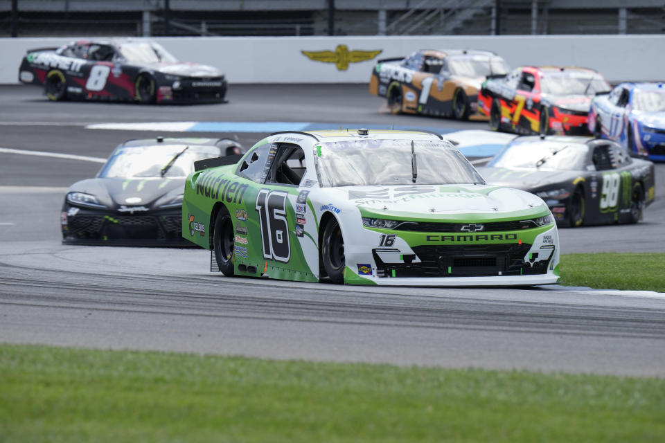 AJ Allmendinger (16) leads the pack on the opening lap during the running of a NASCAR Xfinity Series auto race at Indianapolis Motor Speedway, Saturday, July 30, 2022, in Indianapolis. (AP Photo/AJ Mast)