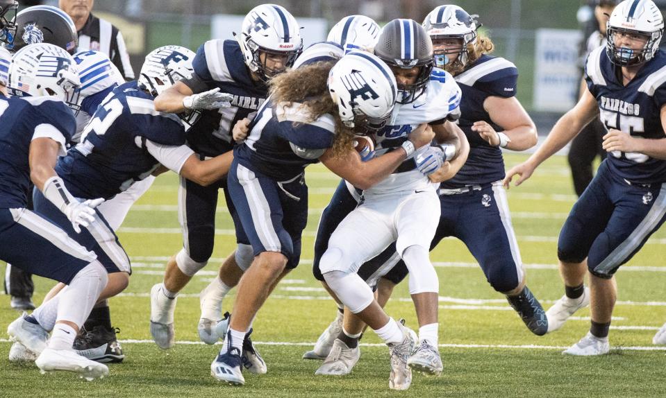 The Fairless defense, led by Coltin Colucci (center), stops CVCA’s Dillon Webb on Friday, Sept. 24, 2021.