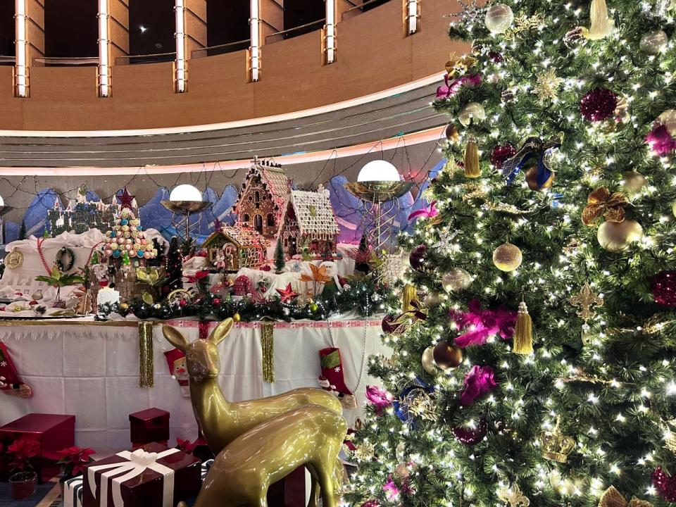 Cruise ship deocrated with gingerbread houses and a large Christmas tree