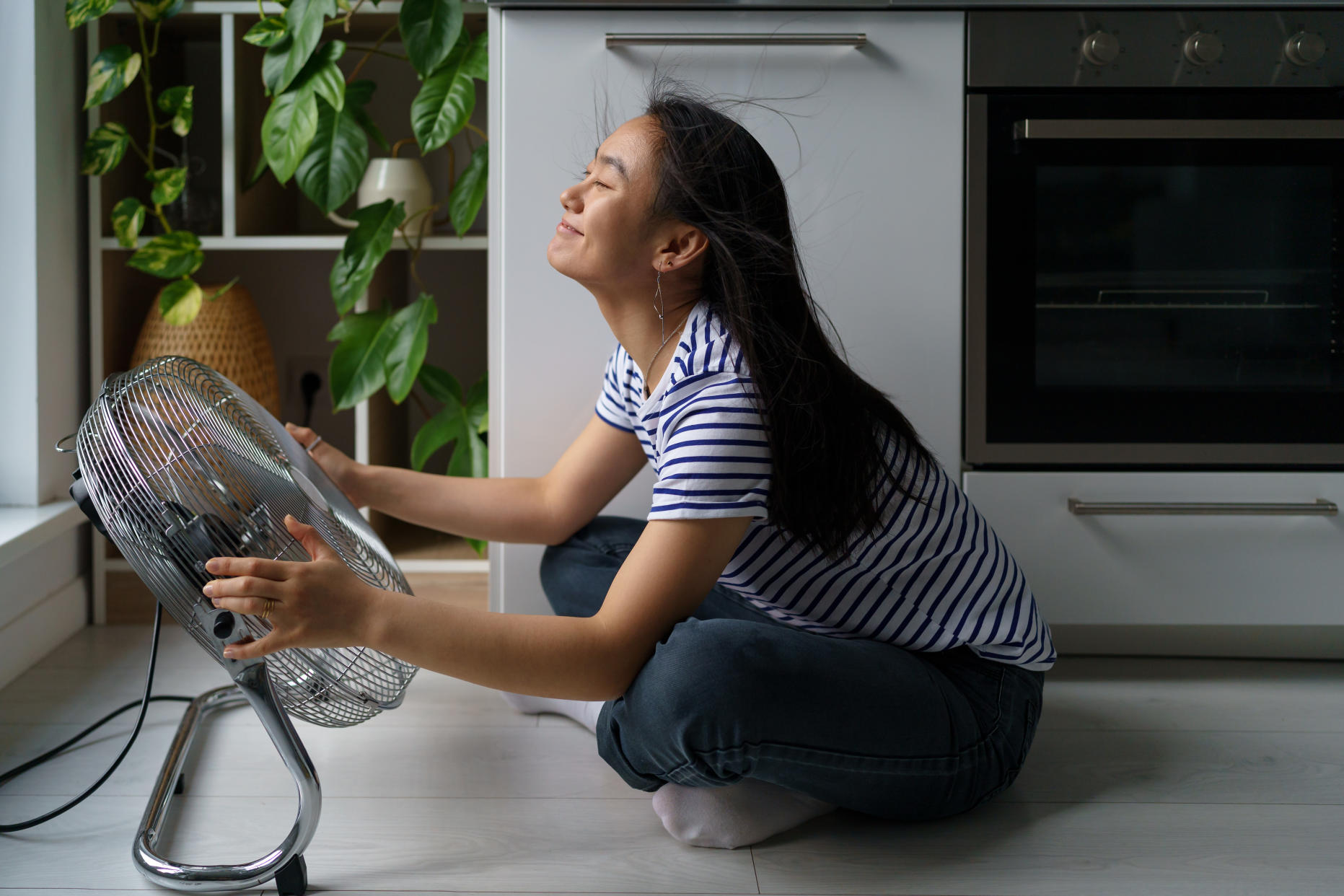 Girl enjoying the ventilation a fan brings