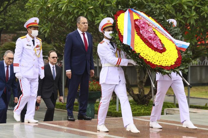 In this photo released by Russian Foreign Ministry Press Service, Russian Foreign Minister Sergey Lavrov, center, walks with a Vietnamese army official to lay wreath at Ho Chi Minh mausoleum in Hanoi, Vietnam on Wednesday July 6, 2022. Lavrov is on a trip to Asia to seek support amid his country's diplomatic isolation by the West and punishing sanctions leveled over its invasion of Ukraine.(Russian Foreign Ministry Press Service via AP)