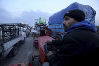 Civilians flee a Syrian military offensive in Idlib province on the main road near Hazano, Syria, Tuesday, Dec. 24, 2019. Syrian forces launched a wide ground offensive last week into the northwestern province of Idlib, which is dominated by al-Qaida-linked militants. The United Nations estimates that some 60,000 people have fled from the area, heading south, after the bombings intensified earlier this month. (AP Photo/Ghaith al-Sayed)