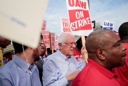 FILE PHOTO: Democratic U.S. presidential candidate Senator Bernie Sanders carries a Strike sign with striking United Auto Workers (UAW) in Hamtramck,