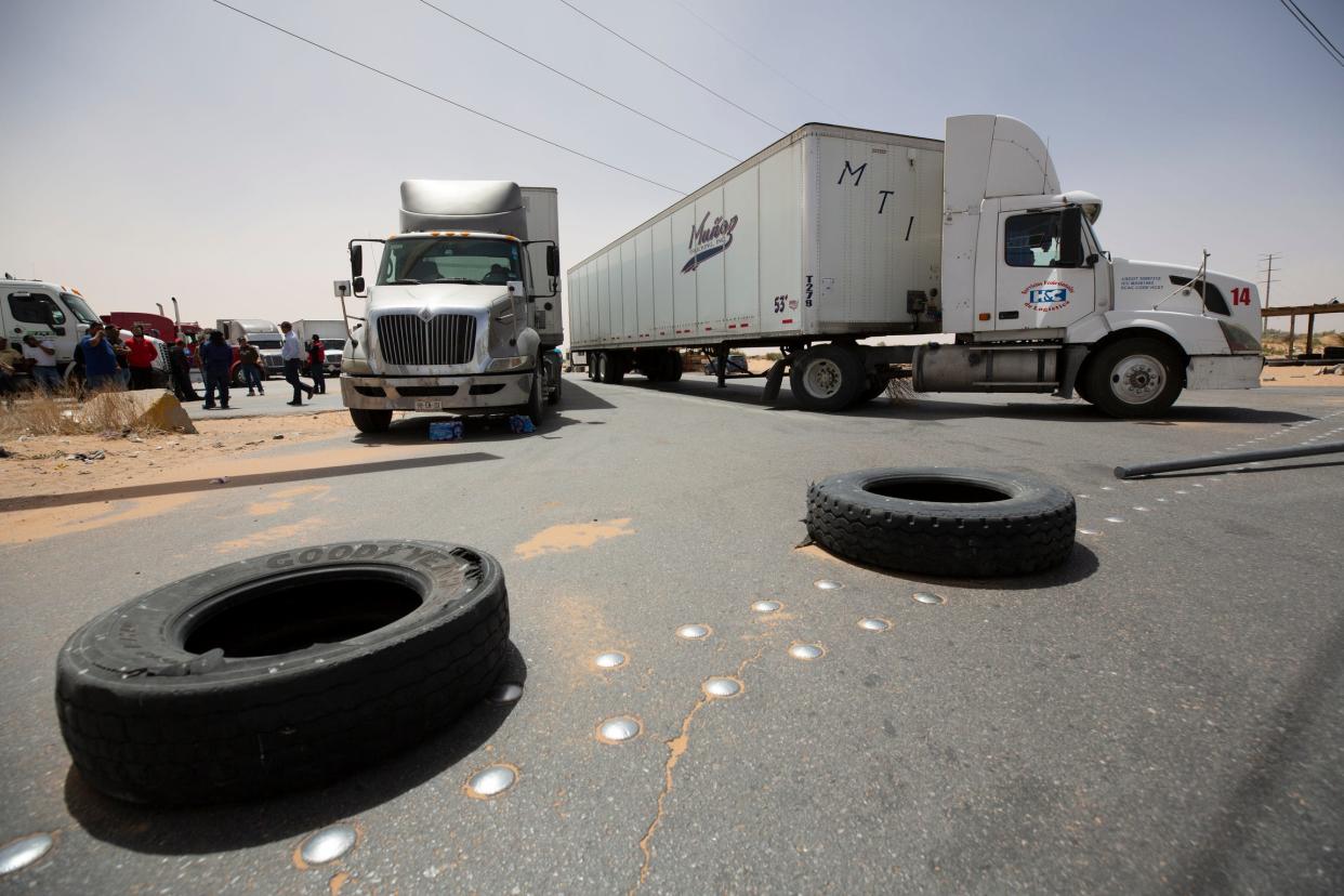 Truckers block the entrance into the Santa Teresa Port of Entry in Ciudad Juarez, Mexico, going into New Mexico on Tuesday. The truckers blocked the port as a protest against the prolonged processing times implemented by Texas Gov. Greg Abbott which they say have increased from two-three hours up to 14 hours in the last few days.