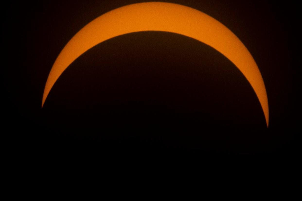 The moon eclipses the sun during the solar eclipse watch party at the downtown branch of the St. Joseph County Public Library in South Bend on Monday, Aug. 21, 2017.