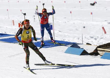 Biathlon - IBU World Championships - Women 12.5 km Mass Start - Hochfilzen, Austria - 19/2/17 - Laura Dahlmeier of Germany and Gabriela Koukalova of Czech Republicleave the shooting range. REUTERS/Leonhard Foeger