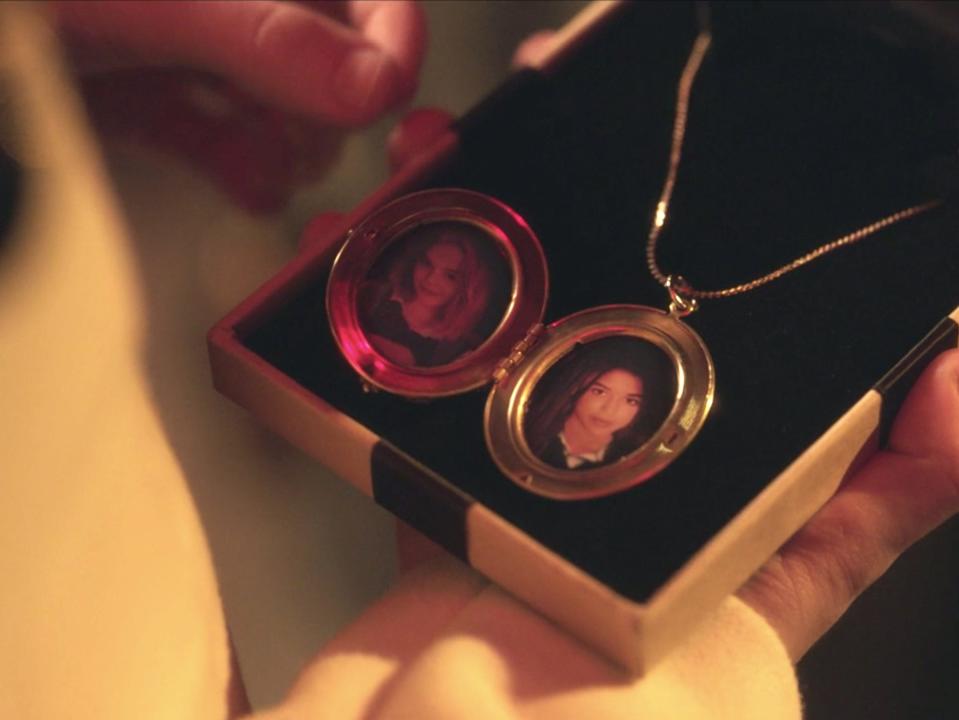 A girl holding a box containing an open locket on season one of "Gossip Girl."