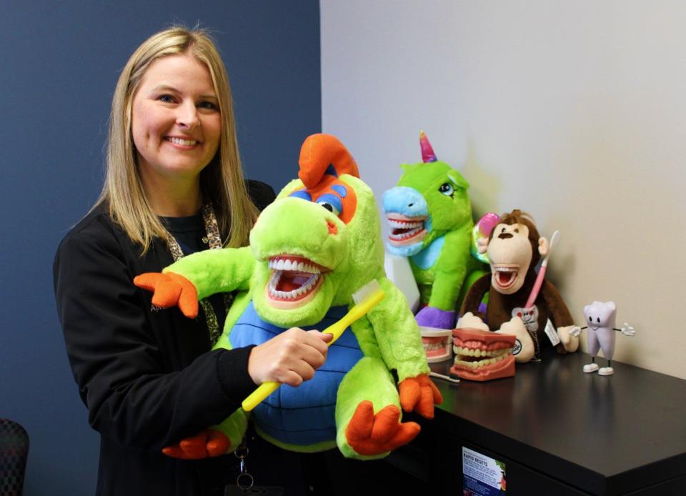 April Brown, dental hygienist for the Henderson County Department of Public Health, with her puppet Max. Brown uses Max and other puppets and tools to teach children about brushing, flossing and basic dental hygiene in a fun and memorable way.