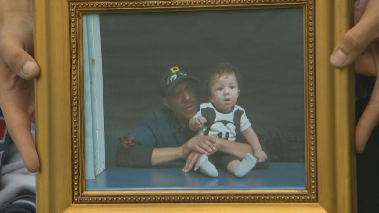 Martin David, shown here in a photograph with one of his children, was a father of four. He died after a fall on June 9, 2020, at a warehouse in Halifax. (Mark Crosby/CBC - image credit)