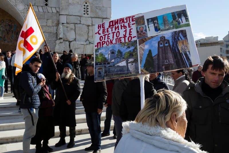 People gather at the Cathedral of the Resurrection of Christ ahead of a parliament vote for a bill on 'Religious freedoms and legal rights of religious organizations' in Podgorica