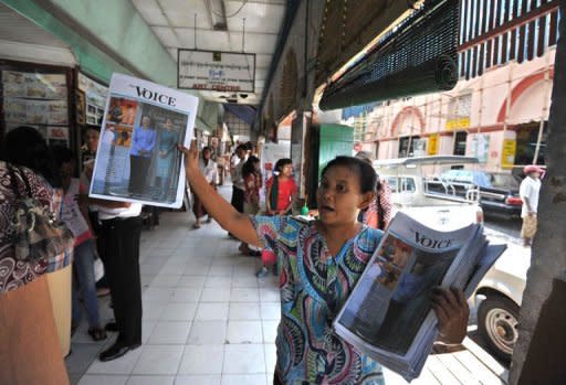A woman sell a local journal with an image of democracy icon Aung San Suu Kyi on the front page in Yangon in December 2011. Myanmar is poised to adopt a new media law that could sweep away decades of censorship, as the press cautiously test the boundaries of newly-won freedoms
