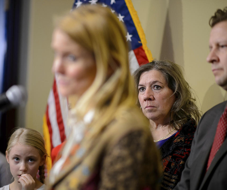 Valley View Elementary School teacher Moana Patterson, back right, listens as Tiffany Ivens-Spence speaks at a news conference by parents and students to show support for Patterson, in Salt Lake City, Monday, March 11, 2019. Ivens-Spence is the parent of a student at the school. Patterson, who is on administrative leave, apologized Monday for making 9-year-old Catholic student William McLeod wash off the Ash Wednesday cross from his forehead the week before, saying it was a misunderstanding. (Trent Nelson/The Salt Lake Tribune via AP)