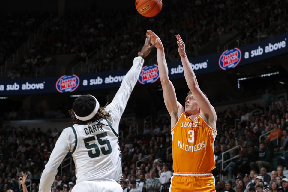 Tennessee's Dalton Knecht, right, shoots against Michigan State's Coen Carr (55) during the first half of an NCAA college basketball exhibition game, Sunday, Oct. 29, 2023, in East Lansing, Mich. (AP Photo/Al Goldis)