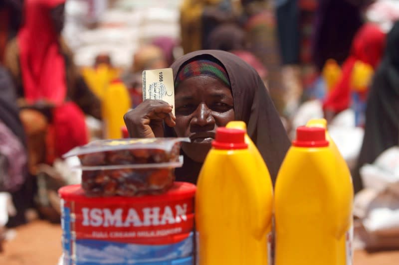 FILE PHOTO: An internally displaced Somali woman receives relief food at a distribution centre organized by a Qatar charity after fleeing from drought stricken regions in Baidoa, west of Somalia's capital Mogadishu