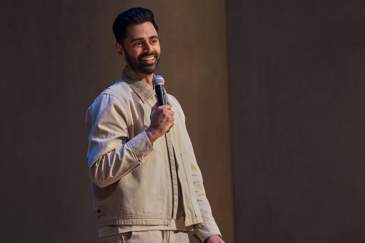 Comedian Hasan Minhaj performs at the Brooklyn Academy of Music. The New Yorker magazine recently published an article detailing how Minhaj overexaggerated or fabricated parts of his standup comedy act. (Clifton Prescod/Netflix - image credit)