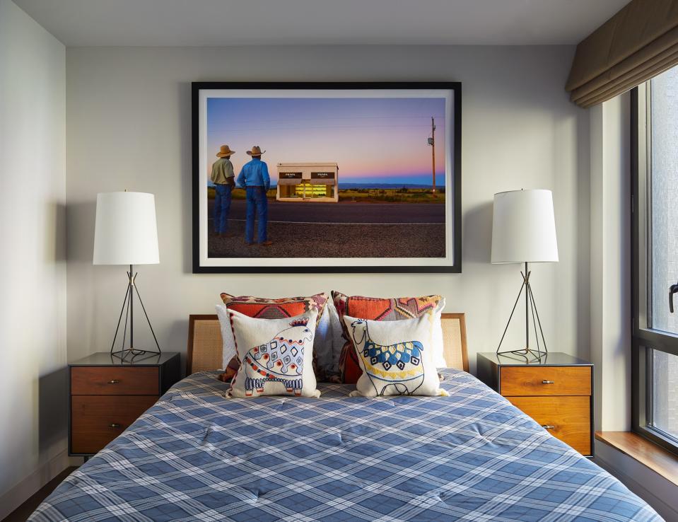 The guest bedroom’s focal point is an arresting photograph by Grey Malin. The two animal pillows are from West Elm: “I think we had those fellows at our very first place together, years and years ago,” Mikita says. “So, they’ve made it through the test of time.” The bed linens are from Thread Experiment, with side tables from Aero Studio and table lamps from Circa Lighting.