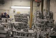 Workers at Mitchell Aerospace a manufacturer of light alloy sand castings for the aerospace industry