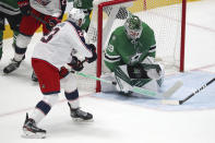 Columbus Blue Jackets left wing Stefan Matteau (23) shoots on Dallas Stars goaltender Jake Oettinger (29) during the first period during an NHL hockey game Thursday, April 15, 2021, in Dallas. (AP Photo/Richard W. Rodriguez)