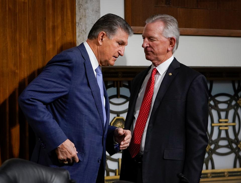 Sen. Joe Manchin (D-W.Va.), left, and Sen. Tommy Tuberville (R-Ala.) introduced a bill to address NIL in college sports.