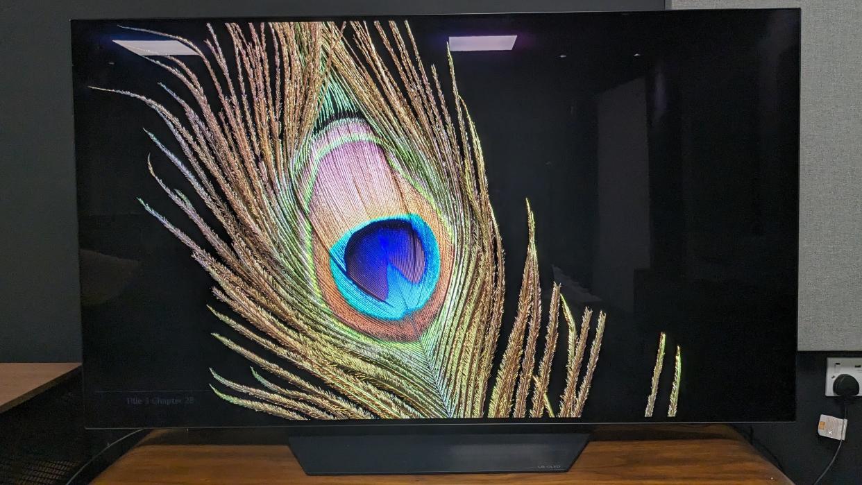  LG B3 TV with peacock feather on screen . 