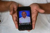 The Wider Image: Indians share the stories of loved ones they lost to the pandemic