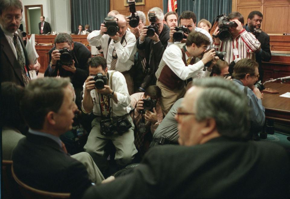 Photographers take pictures of David E. Kendall and Charles C. Ruff, White House counsel, as they wait for the start of the hearing before the House Judiciary Committee regarding articles of impeachment against President Bill Clinton. (