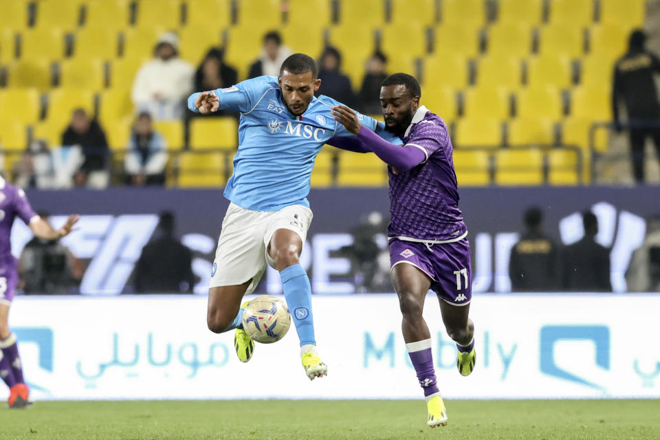 Napoli's Juan Jesus, left, fights for the ball with Fiorentina's Jonathan Ikone during the Italian Super Cup Semi-final soccer match between Fiorentina and Napoli at Al Awwal Park Stadium in Riyadh, Saudi Arabia, Thursday, Jan. 18, 2024. (AP Photo)