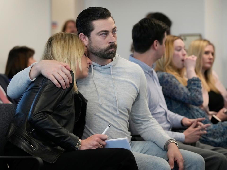 Amanda Zurawski, who nearly died of sepsis when she was denied an abortion after a premature water break, is comforted by her husband, Josh, after she spoke at Friday's meeting.