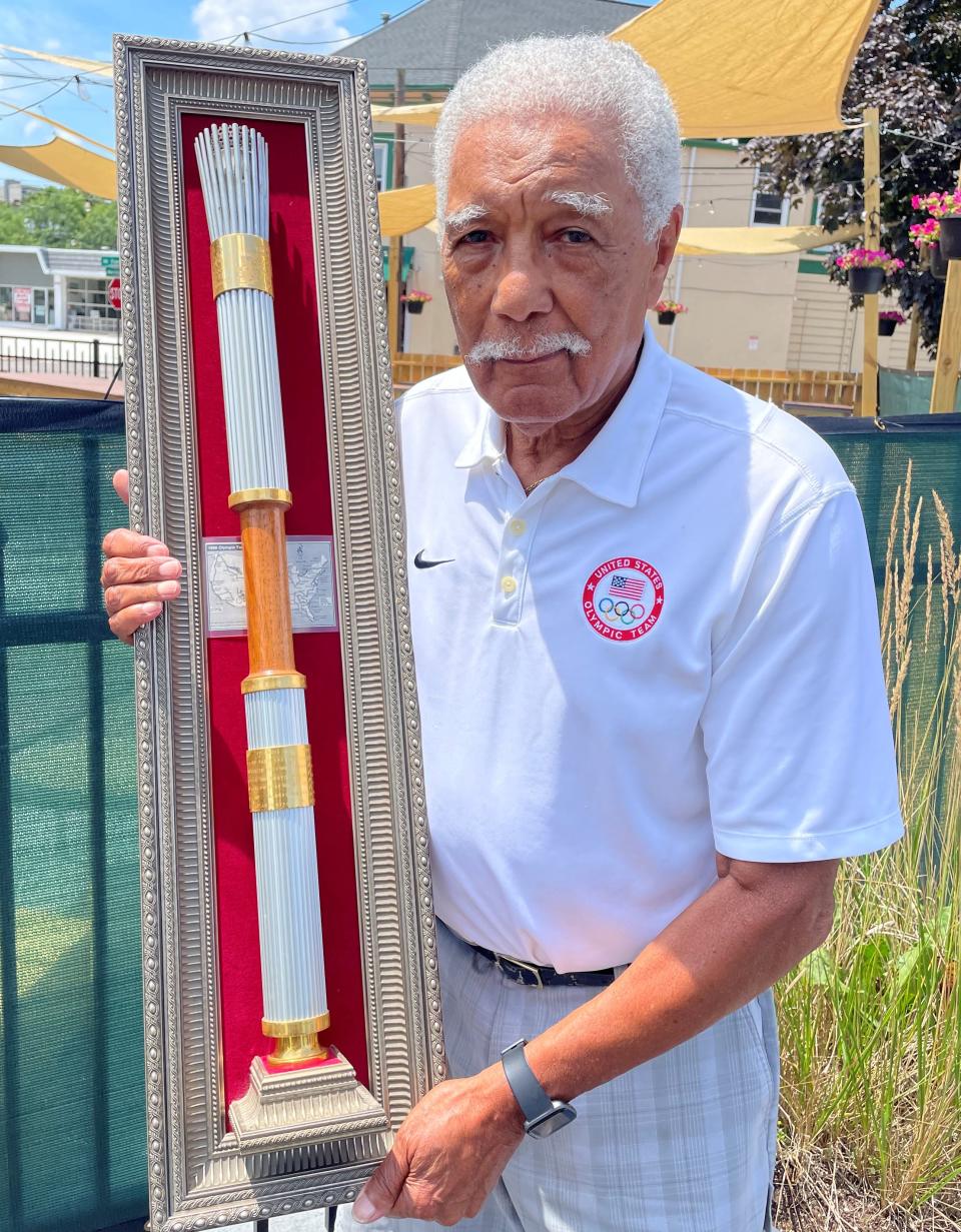 Longtime Akron resident Lester Carney with the torch he carried for a relay preceding the 1996 Atlanta Olympics.