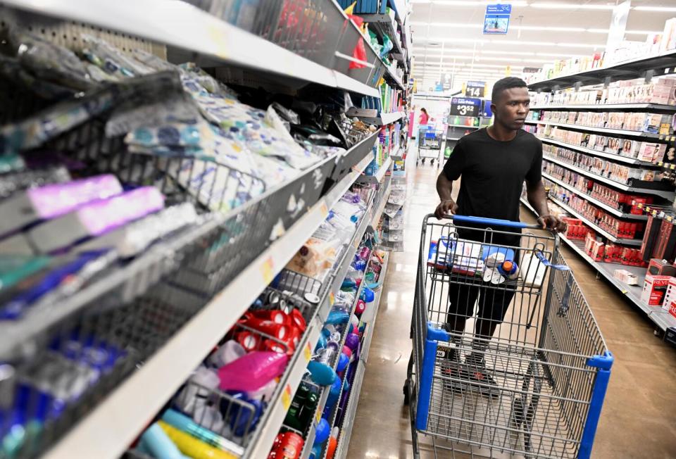 Frederick Keys player Dennis Kasumba shops at Walmart in Frederick, Md.