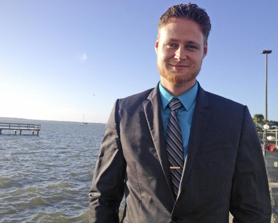 In this photo taken on Thursday, March 6,2 014, Lucas Overby, a 27-year-old Pinellas County resident, campaigns for Congress in Dunedin, Fla. Overby is the Libertarian candidate running against Democrat Alex Sink and Republican David Jolly. (AP Photo/Tamara Lush)