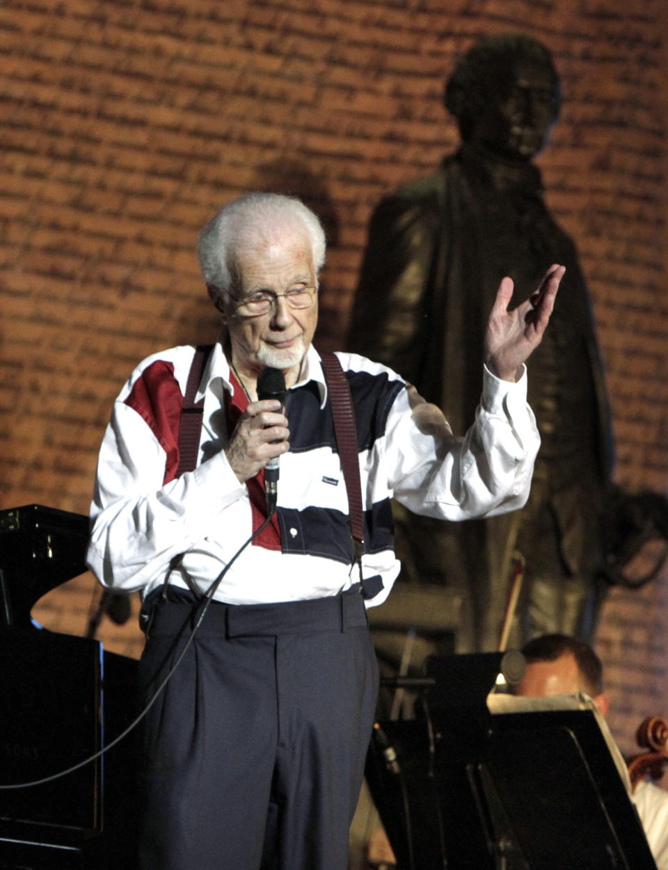 FILE - Musical Conductor Peter Nero says a quick goodnight to the audience, then with a wave to the orchestra, walks off the stage after a Philly Pops concert at Independence Mall in Philadelphia, Wednesday, July 3, 2013. This was Nero's last performance with the Philly Pops. Nero, a Grammy-winning pianist who interpreted pop songs through classical and jazz forms and served as the Philly Pops' conductor for more than three decades, died Thursday, July 6, 2023. He was 89. (Elizabeth Robertson/The Philadelphia Inquirer via AP, File)